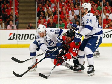 Brad Richards #91 of the Chicago Blackhawks fights for the puck against Andrej Sustr #62 and Ryan Callahan #24 of the Tampa Bay Lightning during Game Six of the 2015 NHL Stanley Cup Final at the United Center  on June 15, 2015 in Chicago, Illinois.