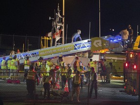 A New York state trooper walks up a Hogansburg-Akwesasne Fire Dept. ladder used to rescue people from the Saint Laurent cruise ship Thursday, June 18, 2015, after an accident in Massena, N.Y.  Authorities say the cruise ship crashed into a wall in a lock on the St. Lawrence Seaway in upstate New York, injuring 30 people and forcing the draining of the lock. The U.S. Coast Guard says the 286-foot Saint Laurent was headed from Montreal to Toronto when it hit a wall in the Eisenhower Lock in Massena, near the Canadian border, around 9:45 p.m. Thursday. There were 274 French passengers and crew aboard.