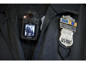 A Philadelphia Police officer demonstrates a body-worn camera.