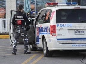 A police officer arrives at a scene of a fatal shooting in the north end of Montreal on Monday, Dec. 1, 2014.
Statistics Canada reported today that despite a slight increase in homicides, violent crime overall in Canada fell for the eighth straight year in 2014. The downward trend came as the agency reported serious crime in general fell to its lowest relative level since 1969 — marking 11 straight years of declines.