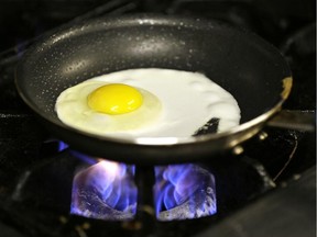 A fried egg on a gas stove.