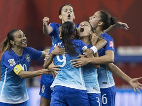 Teammates gather around Brazil's Andressa Alves (9) after she scored the only goal in a 1-0 win over Spain at the FIFA Women's World Cup at Montreal's Olympic Stadium on June 13, 2015.