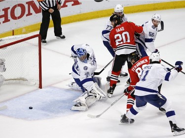 Tampa Bay Lightning goalie Ben Bishop, left, watches as a puck slides wide of the net during the first period in Game 6 of the NHL hockey Stanley Cup Final series against the Chicago Blackhawks on Monday, June 15, 2015, in Chicago.