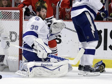Tampa Bay Lightning goalie Ben Bishop looks off after losing his helmet during the second period in Game 6 of the NHL hockey Stanley Cup Final series against the Chicago Blackhawks on Monday, June 15, 2015, in Chicago.
