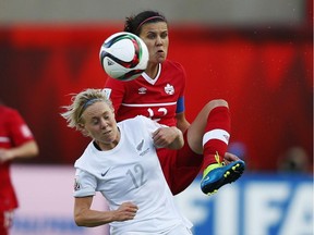 Christine Sinclair (R) of Canada and Betsy Hassett of New Zealand battle for the ball during the FIFA Women's World Cup Canada Group A match between Canada and New Zealand at Commonwealth Stadium on June 11, 2015 in Edmonton.