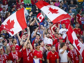 Canadian fans cheer during FIFA Women's World Cup game against New Zealand at Edmonton's Commonwealth Stadium on June 11, 2015. The game ended in a 0-0 tie.