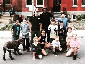 Canadiens defenceman P.K. Subban poses with kids in Westmount after stopping to play ball hockey with them on June 7, 2015. Eight-year-old Jack Fraser is on the right wearing a Canadiens practice jersey with his 14-year-old brother Gabriel behind him.