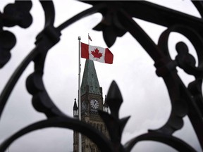 Centre Block's Peace Tower is shown through the gates of Parliament Hill.