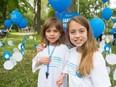 Charlotte, right, who has cystic fibrosis, with her younger sister in Lafontaine Park, where they were among 350 people participating in Sunday's 5K walk to raise funds for cystic fibrosis research in Quebec.