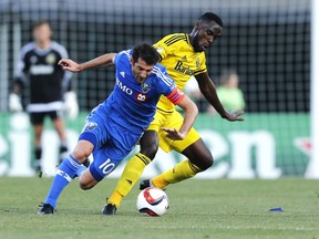 Columbus Crew midfielder Tony Tchani (6) tries to keep the ball from Montreal Impact midfielder Ignacio Piatti (10) during the first half of a soccer match, Saturday, June 6, 2015 in Columbus, Ohio.