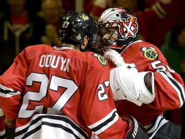 Chicago Blackhawks goalie Corey Crawford, right, and teammate Johnny Oduya, of Sweden, celebrate following the Blackhawks' 2-1 victory over the Tampa Bay Lightning in Game 4 of the NHL hockey Stanley Cup Final Wednesday, June 10, 2015, in Chicago. The series is tied 2-2.