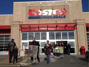 Customers walk out of Costco in Montreal on Saturday, Nov. 17, 2012.