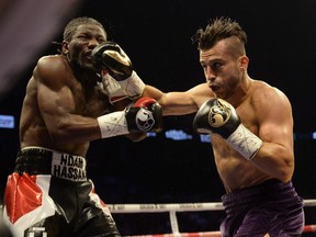 David Lemieux, right, lands a right hand to the face of Hassan N'Dam as they battle for the vacant International Boxing Federation middleweight championship Saturday, June 20, 2015, in Montreal.