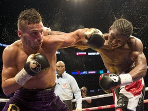 David Lemieux, left, from Laval, trades punches with Hassan N'Dam, from France, during the 12th round of their fight for the vacant IBF world middleweight championship Saturday, June 20, 2015, in Montreal. Lemieux won the bout with a unanimous decision.