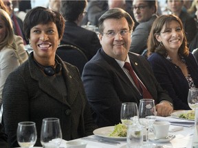 Montreal Mayor Denis Coderre sits with Paris Mayor Anne Hidalgo, right, and Washington, D.C. Mayor Muriel Bowser, left, during a luncheon at the Summit of Cities, Thursday, June 11, 2015 in Montreal.