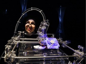 Designer Susana Soares looks through a 3D printer that makes biscuits from flour made from insects at the Wellcome Collection in London, Tuesday, April 23, 2013. The exhibition of Illuminated room-high insect traps, dramatic Iight projections of creepy crawlies and 3D printing of food made from bugs is a new installation called Insects au Gratin which explores the benefits of eating bugs, as part of a new season called Who's the Pest? organised with Pestival - the cultural organisation dedicated to our relationship with insects and the natural world.