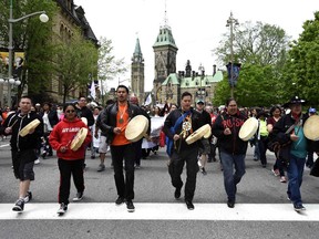 Drummers pass Parliament Hill as they lead the Walk for Reconciliation, part of the closing events of the Truth and Reconciliation Commission on Sunday, May 31, 2015 in Ottawa. Beginning in the 1870s, over 150,000 First Nations, Metis and Inuit children were required to attend government-funded, church-run residential schools in an attempt to assimilate them into Canadian society; the last school closed in 1996. Students were prohibited from speaking their own languages, practicing their culture and often experienced physical and sexual abuse.