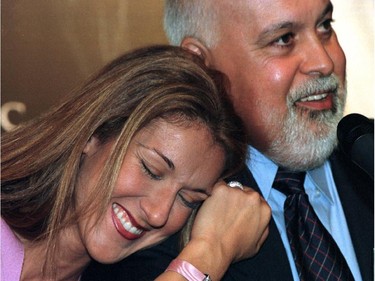 Céline Dion and René Angélil react to reporters' questions at a press conference at the Molson Centre September 8, 1999.