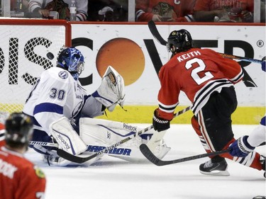 Chicago Blackhawks' Duncan Keith, right, scores past Tampa Bay Lightning goalie Ben Bishop during the second period in Game 6 of the NHL hockey Stanley Cup Final Monday, June 15, 2015, in Chicago.