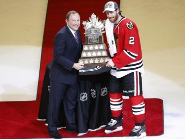 Chicago Blackhawks' Duncan Keith, right, is awarded the The Conn Smythe Trophy by commissioner Gary Bettman after the Blackhawks 2-0 victory over the Tampa Bay Lightning in Game 6 of the NHL hockey Stanley Cup Final series on Monday, June 15, 2015, in Chicago.
