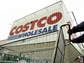 FILE - A shopper pushes a cart outside Costco Wholesale in Danvers, Mass. in this May 27, 2009 file photo. (AP Photo/Elise Amendola, File)