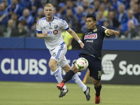 Club America's Osvaldo Martinez (R) controls the ball in front of the Montreal Impact's Callum Mallace during the CONCACAF Champions League return leg final against in Montreal on April 29, 2015.On right is the Impact's Marco Donadel.
