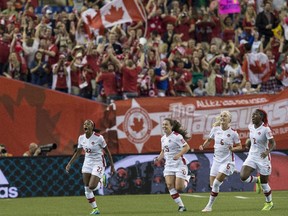 Canada's Ashley Lawrence, left, celebrates scoring against the Netherlands with, from left, Allysha Chapman), Kaylyn Kyle and Kadeisha Buchanan during a 2015 FIFA Women's World Cup Group A match at the Olympic Stadium in Montreal on June 15, 2015.