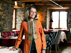 Martha Bate Price, co-owner of Auberge Saint-Antoine, stands in Panache, the hotel’s gourmet restaurant, which features low-slung wooden beams, thick stone and pulleys and dates to the 1800s.