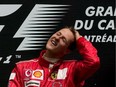 An exhausted Michael Schumacher celebrates on the podium after winning the Canadian Grand Prix at Circuit Gilles Villeneuve on June 13, 2004.