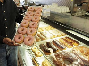 In this April 26, 2011 file photo, doughnuts are displayed in Chicago. The Obama administration is cracking down on artificial trans fats, calling them a threat to public health. The Food and Drug Administration said Tuesday that it will require food companies to phase out the use artificial trans fats almost entirely. Consumers aren't likely to notice much of a difference in their favorite foods, but the administration says the move will to reduce coronary heart disease and prevent thousands of fatal heart attacks every year.