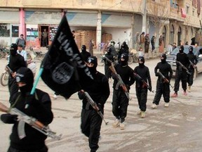 This undated file image posted on a militant website on Tuesday, Jan. 14, 2014, which has been verified and is consistent with other AP reporting, shows fighters from the al-Qaida linked Islamic State of Iraq and the Levant (ISIL), now called the Islamic State group, marching in Raqqa, Syria.