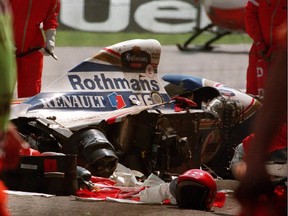 This file photo from May 1, 1994 shows rescuers gathered around the remains of the Williams car of Brazilian Ayrton Senna following his fatal crash at the San Marino Grand Prix. With safety improvements since Senna’s death, not one driver has died while driving an F1 car in a Grand Prix event or in testing.