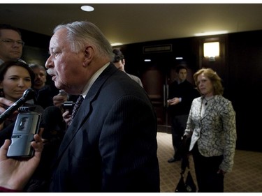 Former Quebec Premier Jacques Parizeau, with his wife Lisette Lapointe looking on, speaks to reporters after addressing public hearings held by the Autorité des marchés financiers on a proposed merger between the Montreal Exchange and the TSX Group Inc. Wednesday March 26, 2008 in Montreal at the Queen Elizabeth Hotel.