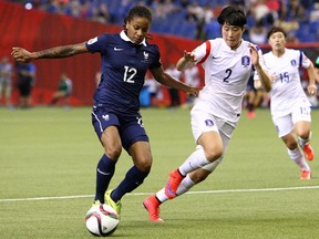 Élodie Thomis of France, left, controls the ball against Eunmi Lee of Korea during the Women's World Cup game at Olympic Stadium on Sunday.