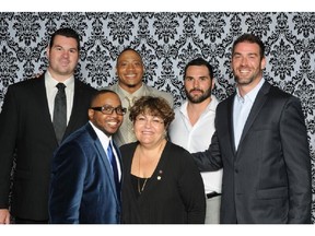 Front row, from left: Denburk Reid, founder of Montreal Community Cares, with Mary Deros, Deputy Mayor, City of Montreal. Back row, from left: Montreal Alouettes players Josh Bourke, John Bowman, Sam Fournier, Éric Deslauriers.