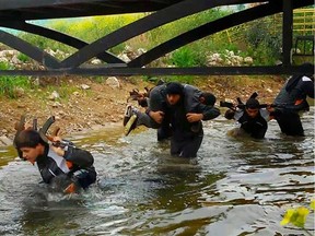 In this photo released on April 30, 2015 by a militant website, which has been verified and is consistent with other AP reporting, new recruits of the Islamic State train in Mosul, northern Iraq.