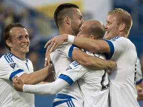 The Impact's Jack McInerney, centre, is congratulated by teammates after scoring a goal against the Vancouver Whitecaps during MLS game at Saputo Stadium on June 3, 2015 in Montreal.