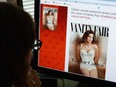 In this June 1, 2015, photo, a journalist looks at Vanity Fair's Twitter site with the Tweet about Caitlyn Jenner, who will be featured on the July cover of the magazine.