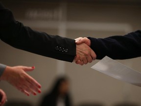 SAN FRANCISCO, CA - JUNE 04:  A job seeker shakes hands with a recruiter during a HireLive career fair on June 4, 2015 in San Francisco, California. According to a report by payroll processor ADP,  201,000 jobs were added by businesses in May.