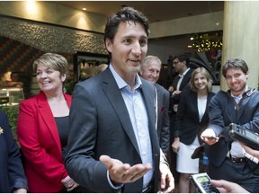 Federal Liberal leader Justin Trudeau speaks to the media after a candidates meeting Friday, June 19, 2015 in Brossard.