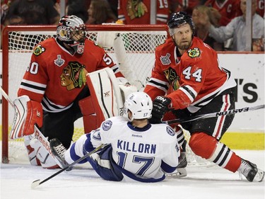 Tampa Bay Lightning's Alex Killorn (17) falls in front of Chicago Blackhawks goalie Corey Crawford, left, and Kimmo Timonen during the first period in Game 4 of the NHL hockey Stanley Cup Final Wednesday, June 10, 2015, in Chicago.