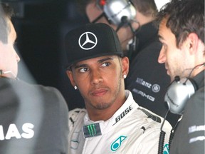 Mercedes driver Lewis Hamilton listens to  technicians during free practice session at the Monaco Grand Prix on May 21 2015. T