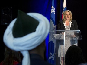 A Muslim man listens to Quebec Public Security Minister Lise Theriault during a news conference to unveil an anti-radicalization strategy, Wednesday, June 10, 2015 in Montreal.