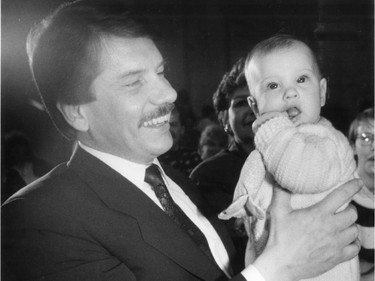 Mayor Jean Doré plays the role of proud father with daughter Magali (six months) before a ceremony introducing the 30 Quebec children travelling to Russia, on Saturday, March 21, 1987.