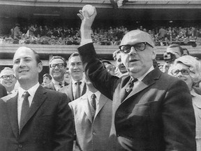 Montreal mayor Jean Drapeau, with Expos owner Charles Bronfman (left), throws out the ceremonial first pitch before the first game in Expos history on April 8, 1969 against the Mets at Shea Stadium in New York.