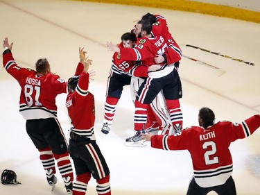 Members of the Chicago Blackhawks' celebrate after defeating the Tampa Bay Lightning in Game 6 of the NHL hockey Stanley Cup Final series on Monday, June 15, 2015, in Chicago. The Blackhawks defeated the Lightning 2-0 to win the series 4-2.