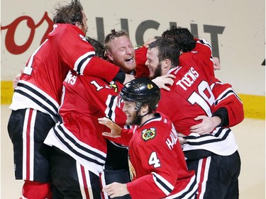 Members of the Chicago Blackhawks celebrate after defeating the Tampa Bay Lightning in Game 6 of the NHL hockey Stanley Cup Final series on Monday, June 15, 2015, in Chicago. The Blackhawks defeated the Lightning 2-0 to win the series 4-2.