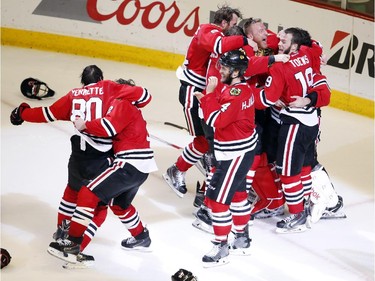 Members of the Chicago Blackhawks celebrate after defeating the Tampa Bay Lightning in Game 6 of the NHL hockey Stanley Cup Final series on Monday, June 15, 2015, in Chicago. The Blackhawks defeated the Lightning 2-0 to win the series 4-2.