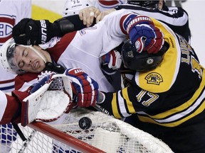 The Boston Bruins' Milan Lucic, right, tangles with Canadiens defenceman Alexei Emelin during playof game in Boston on May 3, 2014.