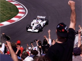 BAR's Jacques Villeneuve is greeted with a standing ovation in the hairpin turn during practice for the Canadian Grand Prix in Montreal on June 7, 2002.